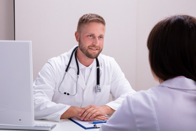 smiling male doctor talking to his patient